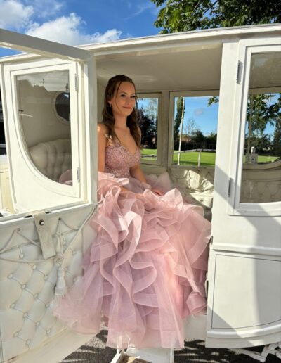 This pink dress stands out brilliantly with the white carriage